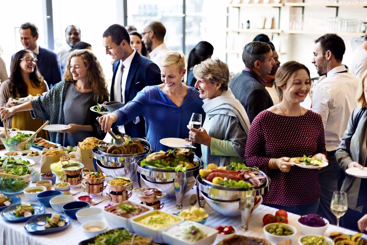 Corporate guests engaging around an elegant buffet
